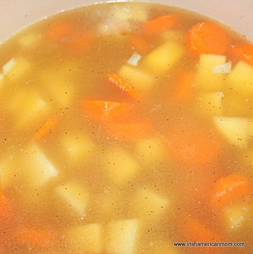 Adding chicken broth for rutabaga and carrot soup | Irish American Mom Adding chicken broth for rutabaga and carrot soup