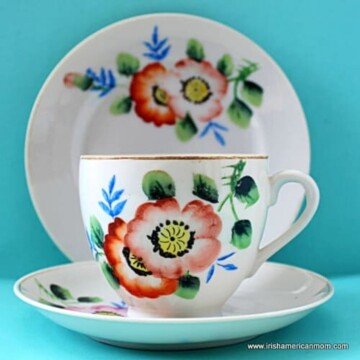 China cup on a saucer with a plate standing behind