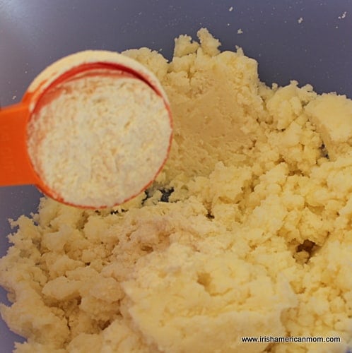 Adding flour to mashed potatoes for potato cakes | Irish American Mom Adding flour to mashed potatoes for potato cakes