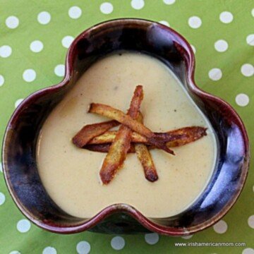 Shomrock shaped bowl of soup with parsnip crisps as garnish