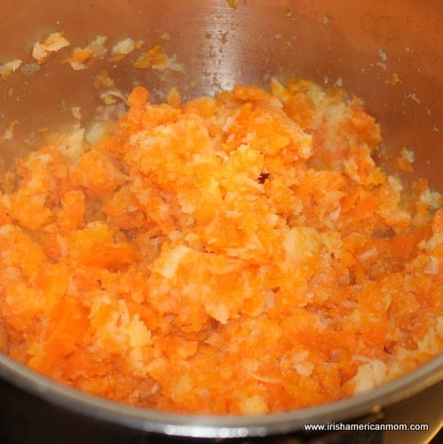 Mashing carrots and parsnips together | Irish American Mom Mashing carrots and parsnips together