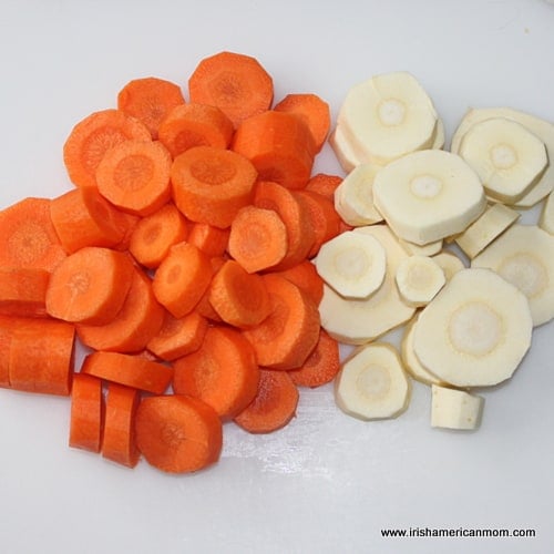 Sliced carrots and parsnips on a chopping board | Irish American Mom Sliced carrots and parsnips