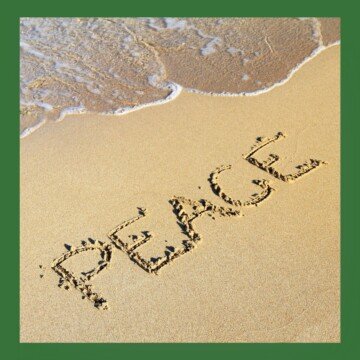 Letters etched in the sand by the shoreline