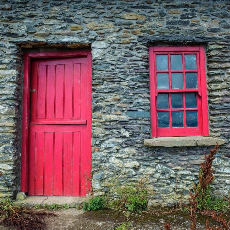 Red Irish Cottage Door and Window | Irish American Mom A stone cottage in Ireland with a red half door and a red cottage window