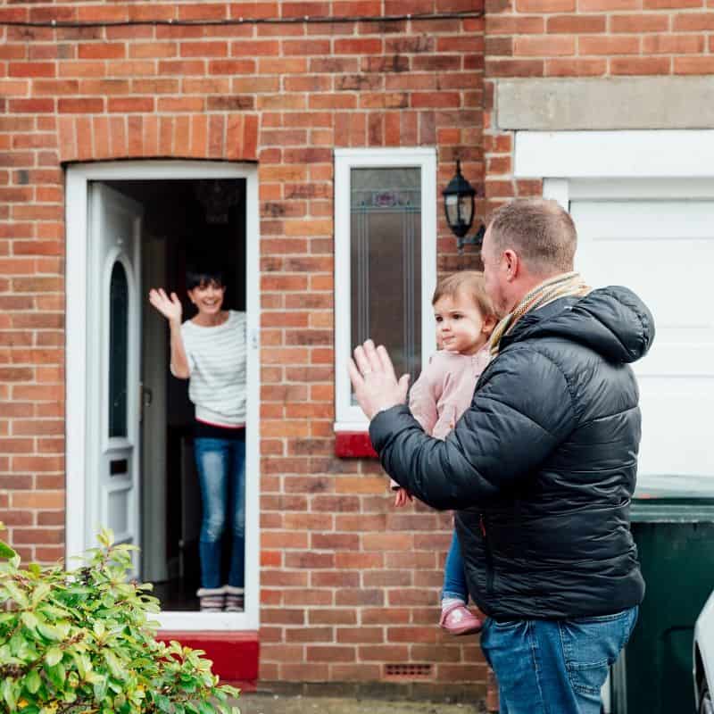 Waving Goodbye at a door | Irish American Mom A family waves goodbye to each other at a house door