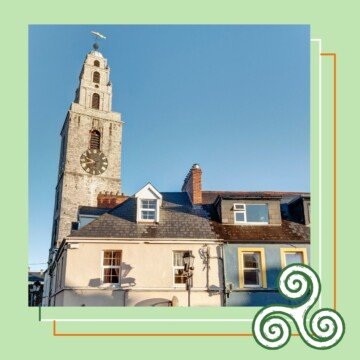 Clock tower beside a row of houses