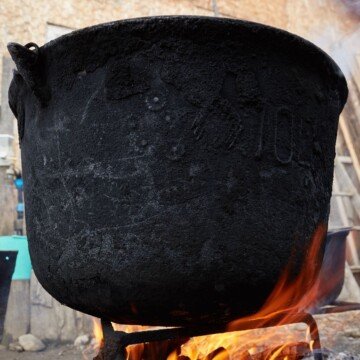 A large cast iron pot on an open fire