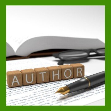 Letters on blocks with a pen, glasses and an open book