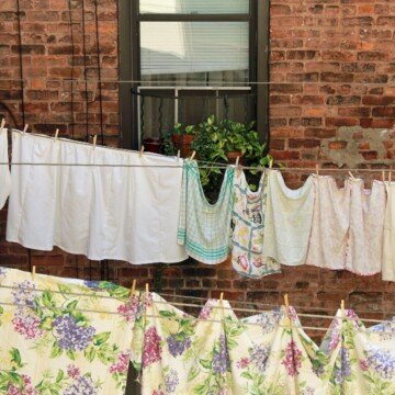 Laundry hanging on lines beside a window