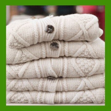 White cardigans folded and stacked