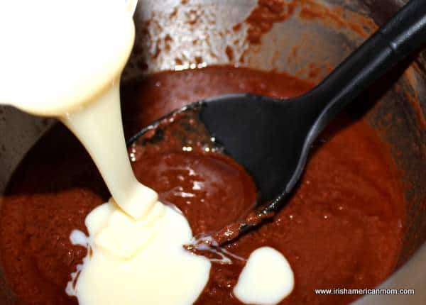 Adding condensed milk to melted chocolate for biscuit cake | Irish American Mom Adding condensed milk to melted chocolate for biscuit cake