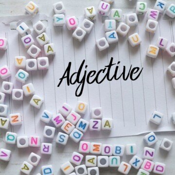 Text in cursive writing on lined paper surrounded by letter blocks