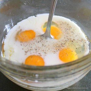 Eggs, milk, salt and pepper in a bowl