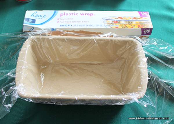 Lining a loaf pan with plastic wrap for chocolate cookie cake | Irish American Mom Lining a loaf pan with plastic wrap for chocolate cookie cake
