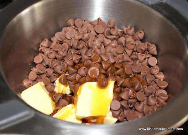 Melting chocolate chips, butter and golden syrup for biscuit cake | Irish American Mom Melting chocolate chips, butter and golden syrup for biscuit cake