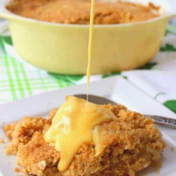 Pouring custard on a serving of apple crumble