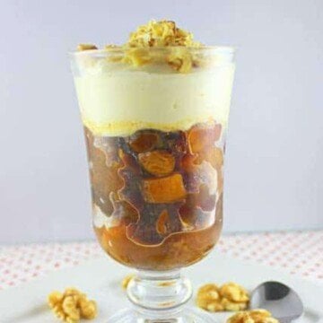 Dried fruit salad with cream topping in a glass
