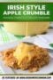 A serving of Irish apple crumble topped with creamy custard being poured over a golden crumb topping on a white plate with text banners.