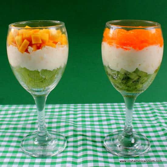 Layered fruit and cream desserts in wine glasses using orange and green colors of the Irish flag | Irish American Mom Layered fruit and cream desserts in wine glasses using orange and green colors of the Irish flag
