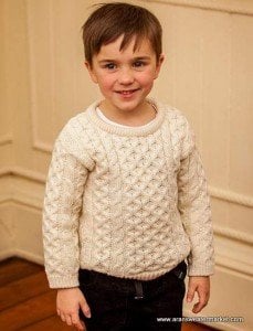 An Irish boy wearing a traditional natural color Irish Aran sweater