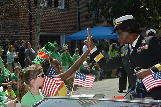 Navy Recruiting Command commander takes part in Savannah's 191st St. Patrick's Day Parade | Irish American Mom Woman and child touch palms during a parade