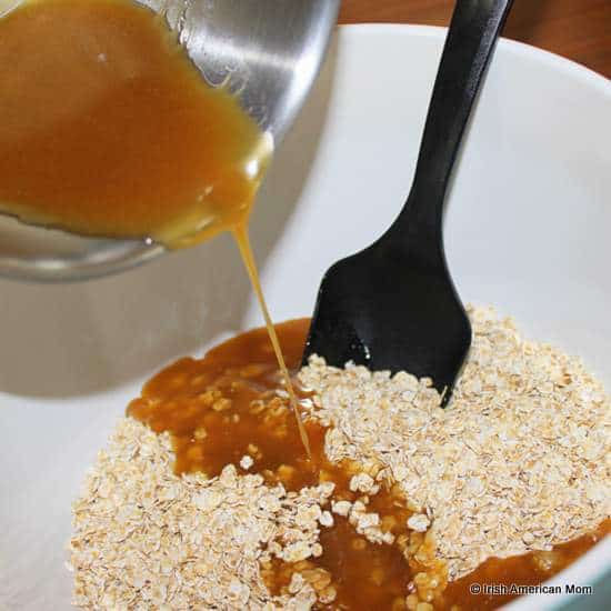 Mixing wet ingredients with dry oatmeal for Irish flapjacks or granola bars | Irish American Mom Mixing wet ingredients with dry oatmeal for Irish flapjacks or granola bars