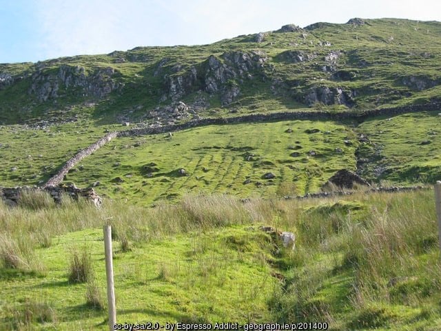 Fields showing signs of old lazy beds for growing potatoes near Killary Harbor | Irish American Mom A walled field with furrows on a hillside