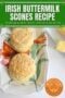 Two golden Irish buttermilk scones on a decorative plate with butter on the side, with text overlay reading “Irish Buttermilk Scones Recipe – Traditional Irish Treats, Perfect with Butter.”