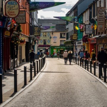 A street in a town with colorful shops and buildings