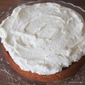 spreading cream inside a sponge sandwich cake
