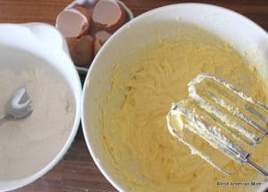Add eggs one at a time to butter sponge batter with a little flour