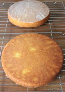 Layers of a sponge sandwich cake cooking on wire racks