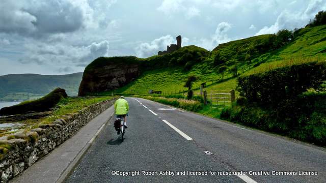 cycling-on-the-antrim-coast-road | Irish American Mom A man riding a bicycle on the side of a mountain road