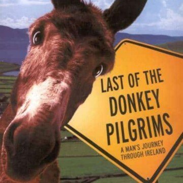 Donkey beside a road sign with text