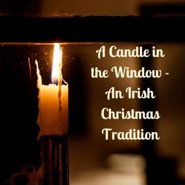 A candle flame seen through a window frame at night with text