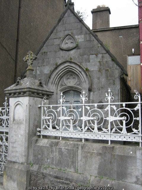 An old stone building with a wall and railing