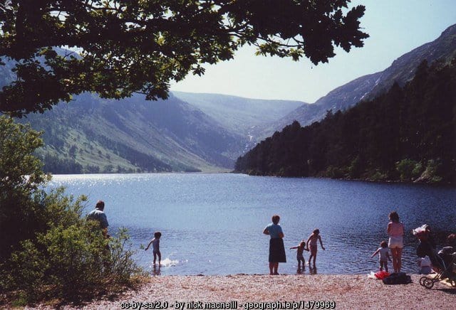 Family standing by the shore of a lake