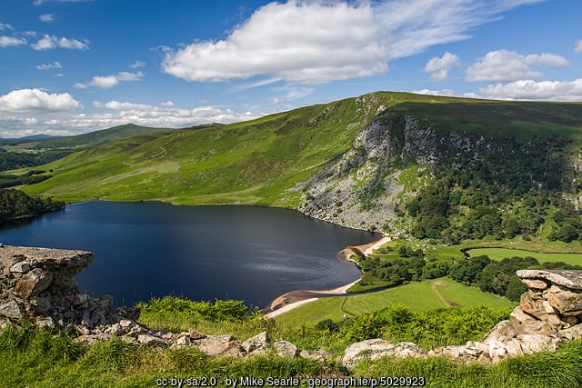Blue lake surrounded by green landscape and mountains