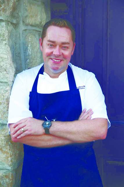 NevinMaguire | Irish American Mom man in blue apron posing for the camera