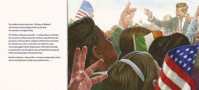 An American flag above a crowd with raised hands