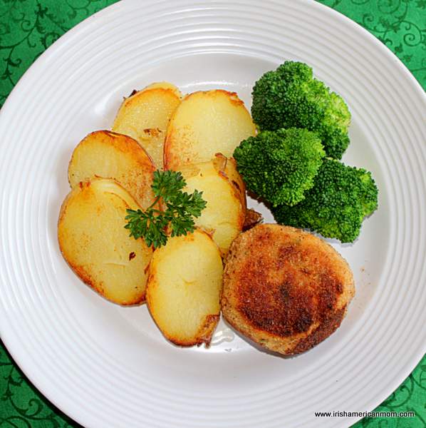 An Irish dinner - salmon cake, fried potatoes and steamed broccoli | Irish American Mom Fried potatoes, broccoli and a salmon cake on a white dinner plate