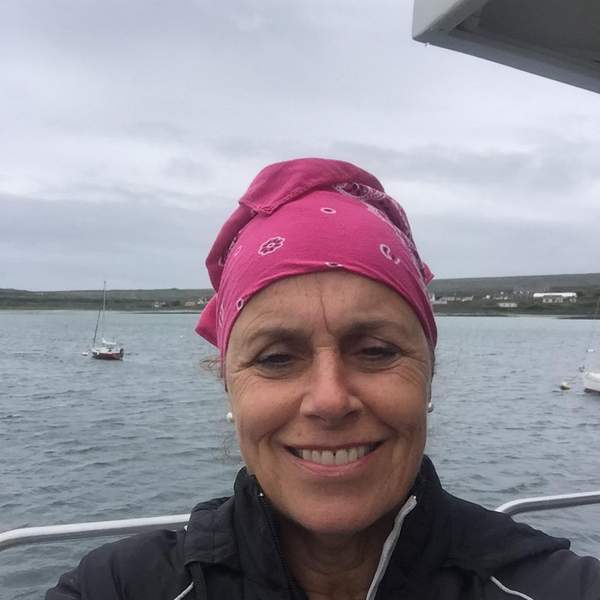 Anne Driscoll Writer in Ireland | Irish American Mom A person smiling next to a body of water
