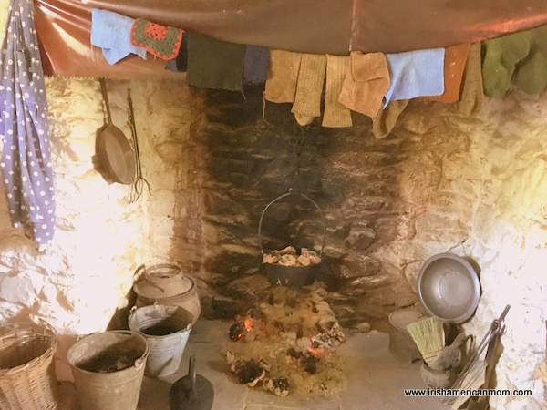 A bastible pot suspended over an open turf fire in Ireland | Irish American Mom A fire burning in a heath with a pot hanging over it and clothes drying on a line
