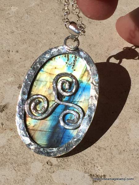 Celtic Triskelion Pendant from Beamagiklamp | Irish American Mom Celtic Triskelion pendant with blue and green background