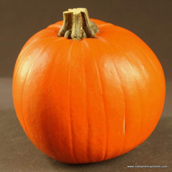 A medium uncut orange pumpkin