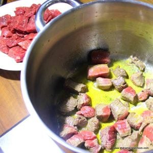 Beef pieces browning in butter in a large saucepan