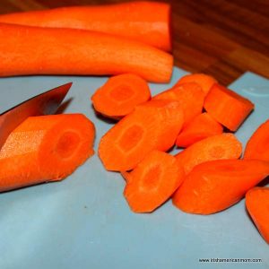Carrots cut in chunks on a chopping board