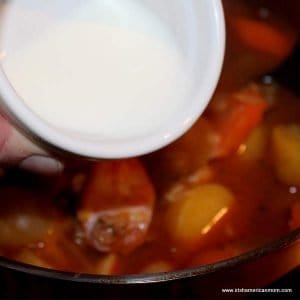 Adding a cornstarch slurry to a pot of stew