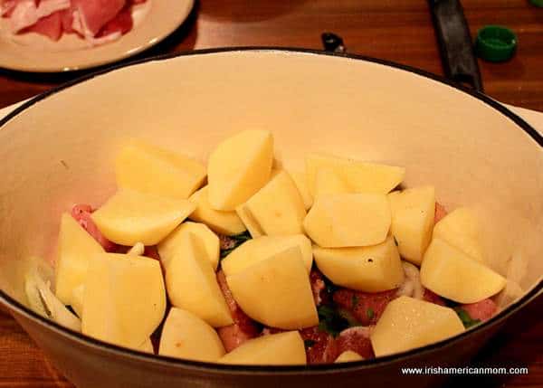 Cubes of potatoes in Dublin Coddle | Irish American Mom Adding cubed potatoes to a pot of coddle