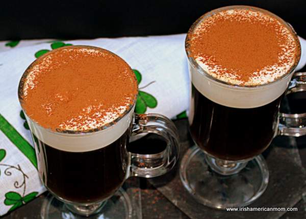 Irish coffee created by Joe Sheridan in 1942 | Irish American Mom Two Irish coffees topped with cocoa powder